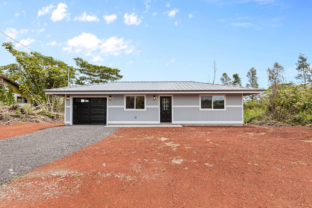 16-2083 Coconut Dr, Pahoa, HI 96778 - view of front of home with an attached garage, gravel driveway, and metal roof