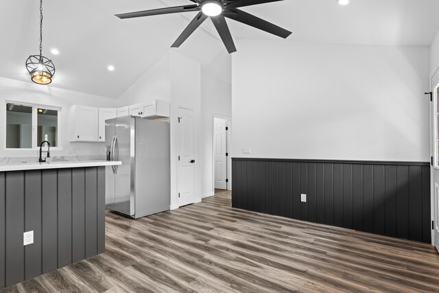 16-2083 Coconut Dr, Pahoa, HI 96778 - kitchen featuring stainless steel fridge, light countertops, ceiling fan, white cabinets, and wood finished floors
