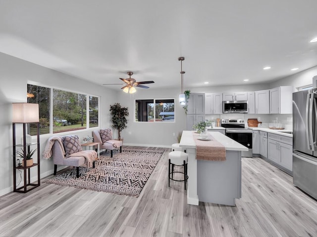 11-3063-A Puolani St, Volcano, HI 96785 - kitchen featuring stainless steel appliances, healthy amount of natural light, a kitchen island, light countertops, and recessed lighting