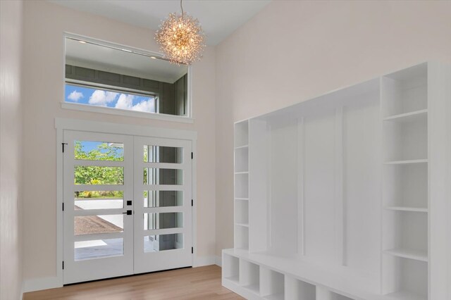 15-1616 7th Ave, Keaau, HI 96749 - mudroom with a chandelier, wood finished floors, a towering ceiling, and french doors
