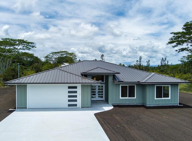15-1616 7th Ave, Keaau, HI 96749 - view of front of property featuring driveway, metal roof, board and batten siding, and a garage
