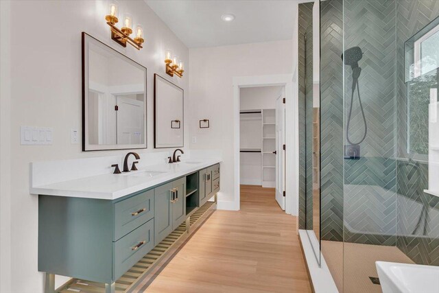 15-1616 7th Ave, Keaau, HI 96749 - bathroom featuring double vanity, wood finished floors, a shower stall, a freestanding bath, and a walk in closet