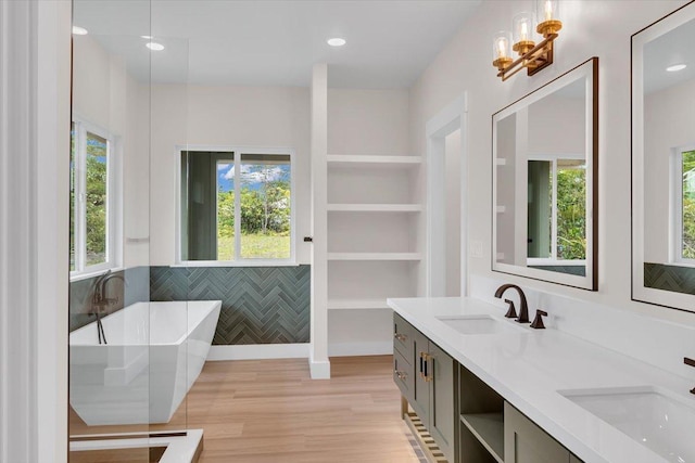 15-1616 7th Ave, Keaau, HI 96749 - bathroom featuring double vanity, a freestanding bath, wood finished floors, and a chandelier