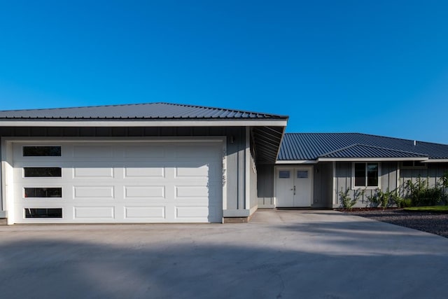68-1787 Niu Haohao Pl, Waikoloa, HI 96738 - view of front of property with metal roof, driveway, board and batten siding, and a garage