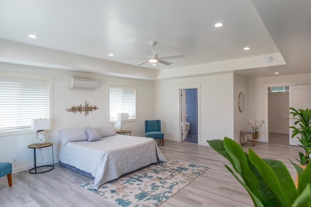 68-1787 Niu Haohao Pl, Waikoloa, HI 96738 - bedroom featuring a wall mounted AC, baseboards, wood finished floors, recessed lighting, and a tray ceiling