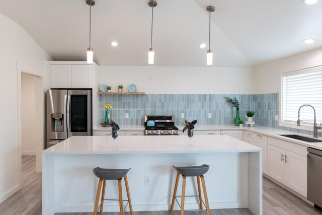 68-1787 Niu Haohao Pl, Waikoloa, HI 96738 - kitchen with stainless steel appliances, a sink, lofted ceiling, decorative backsplash, and light wood-type flooring
