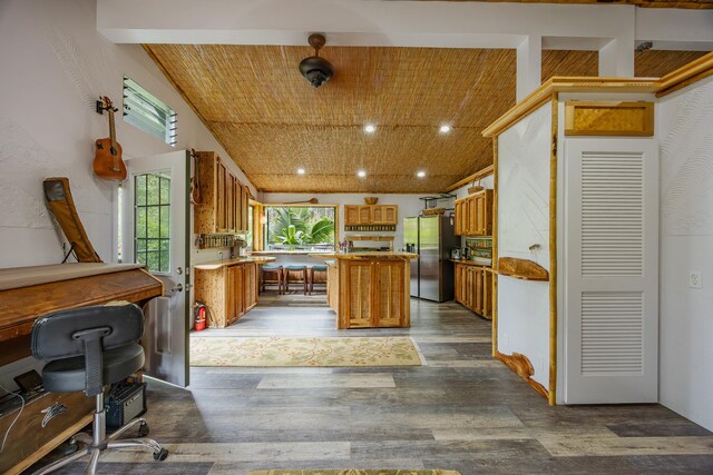 14-3401 Pakalana Rd, Pahoa, HI 96778 - kitchen featuring stainless steel fridge with ice dispenser, brown cabinetry, a kitchen island, dark wood finished floors, and recessed lighting