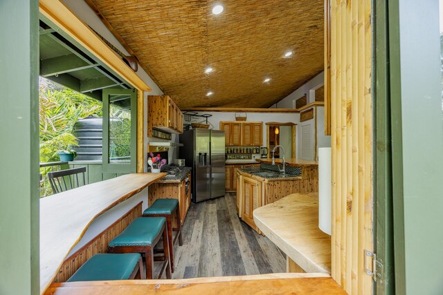 14-3401 Pakalana Rd, Pahoa, HI 96778 - kitchen featuring stainless steel fridge with ice dispenser, a sink, wood finished floors, extractor fan, and recessed lighting