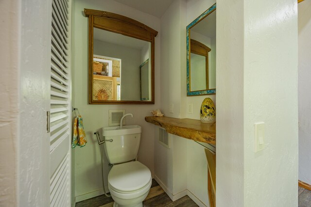14-3401 Pakalana Rd, Pahoa, HI 96778 - half bathroom featuring toilet, wood finished floors, and baseboards