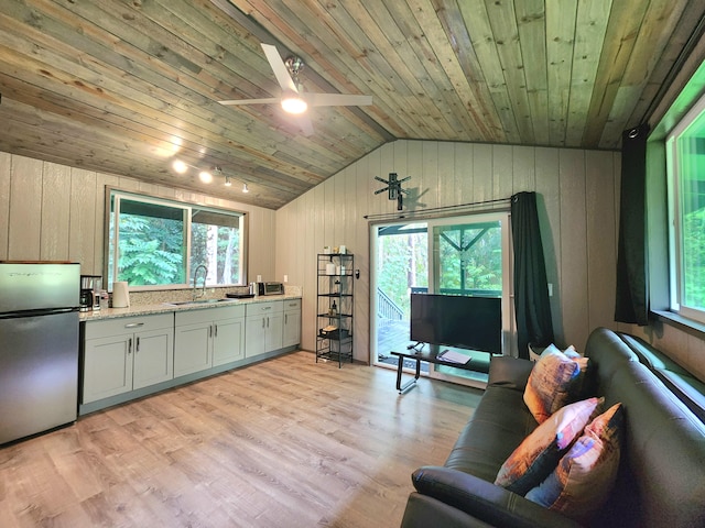 13-831 Malama St, Pahoa, HI 96778 - living room featuring wooden ceiling, vaulted ceiling, wood walls, light wood-style floors, and a ceiling fan