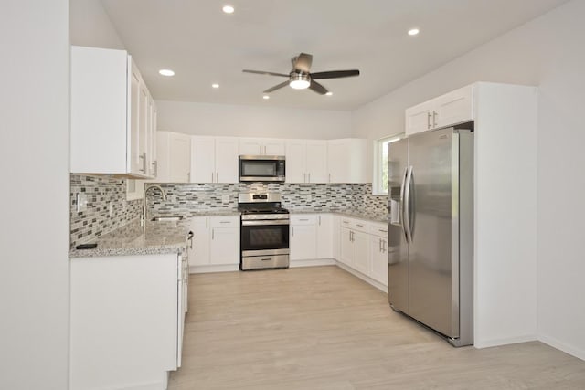 15-1983 27th Ave, Keaau, HI 96749 - kitchen featuring stainless steel appliances, a sink, ceiling fan, backsplash, and light wood-style floors