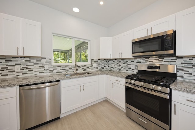15-1983 27th Ave, Keaau, HI 96749 - kitchen with appliances with stainless steel finishes, a sink, white cabinets, decorative backsplash, and light stone counters