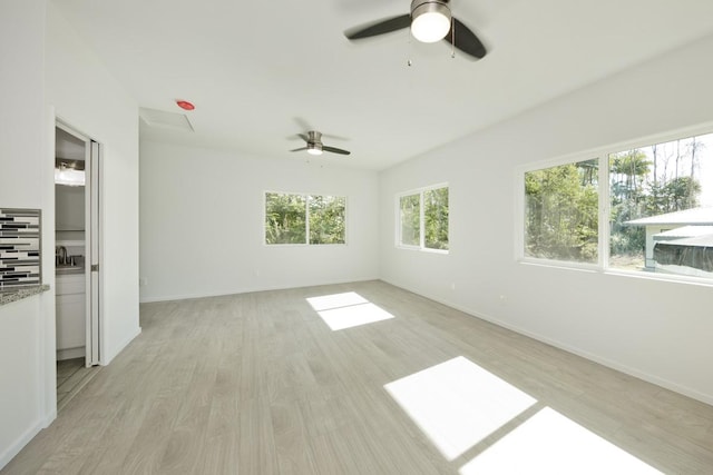 15-1983 27th Ave, Keaau, HI 96749 - unfurnished living room featuring a ceiling fan, light wood-style flooring, baseboards, and a sink