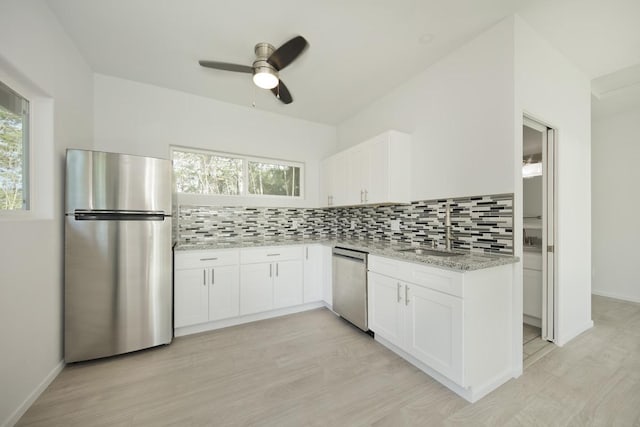 15-1983 27th Ave, Keaau, HI 96749 - kitchen with appliances with stainless steel finishes, a sink, light stone counters, and healthy amount of natural light