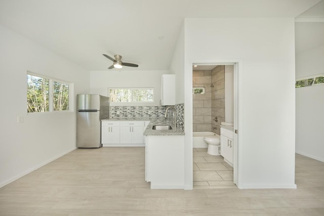 15-1983 27th Ave, Keaau, HI 96749 - kitchen featuring freestanding refrigerator, a sink, a ceiling fan, white cabinetry, and light stone counters
