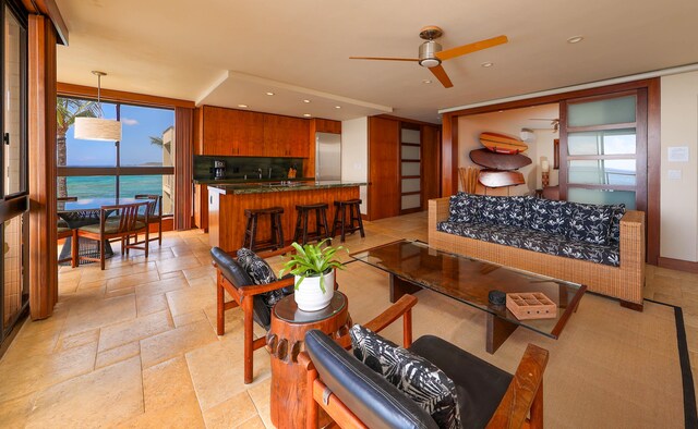 5050 Lawai Rd Unit 413, Koloa, HI 96756 - living area with a ceiling fan, plenty of natural light, stone tile floors, and recessed lighting