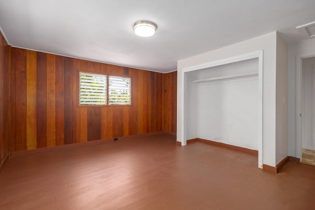 44-3275 Hoo Kahua Rd, Honokaa, HI 96727 - unfurnished bedroom with a closet, wood walls, baseboards, and wood finished floors