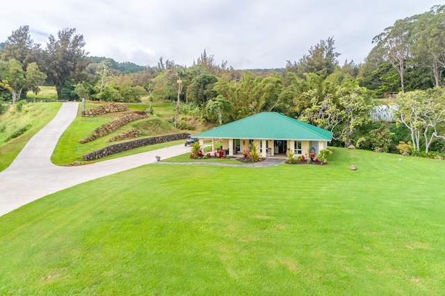 48-5319 Kukuihaele Rd, Honokaa, HI 96727 - view of front of property with covered porch, a front lawn, driveway, and a view of trees