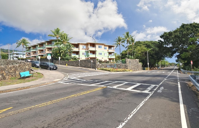 78-216 Makolea St Unit 32, Kailua-Kona, HI 96740 - view of asphalt street featuring traffic signs, street lighting, curbs, and sidewalks