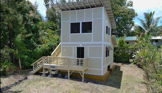12-7026 Wehelauniu St, Pahoa, HI 96778 - rear view of house with a deck, stairway, and stucco siding