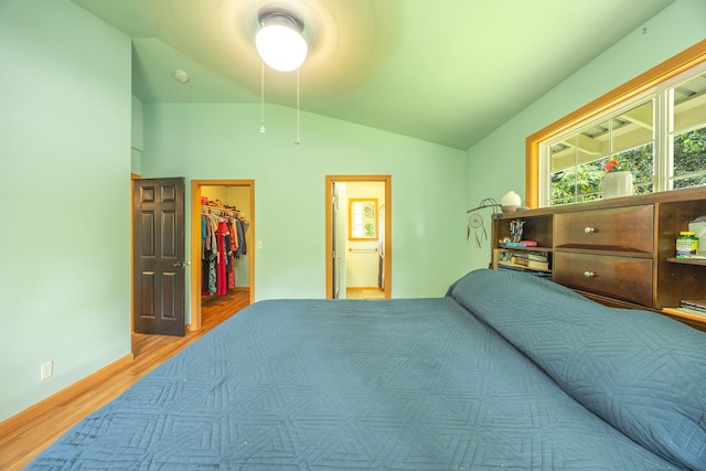 13-3477 Alapai St, Pahoa, HI 96778 - bedroom with wood finished floors, lofted ceiling, multiple windows, and a walk in closet
