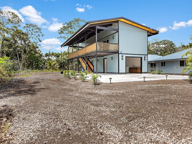 15-2792 Opae St, Pahoa, HI 96778 - rear view of property featuring driveway, stairway, a garage, and a deck