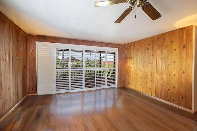 68-1853 W Kaupapa Pl, Waikoloa, HI 96738 - unfurnished room featuring wood finished floors, wooden walls, a ceiling fan, and baseboards