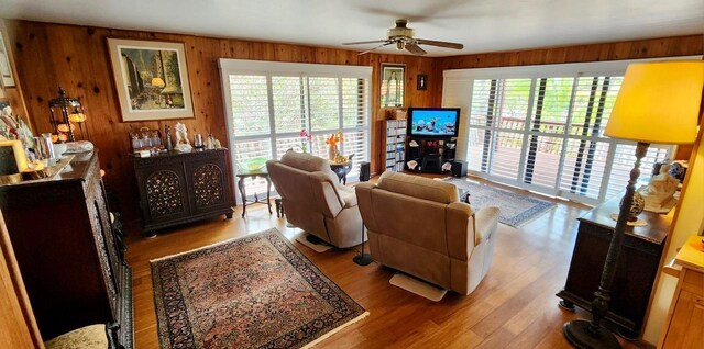 68-1853 W Kaupapa Pl, Waikoloa, HI 96738 - living room with ceiling fan, wood walls, and wood finished floors