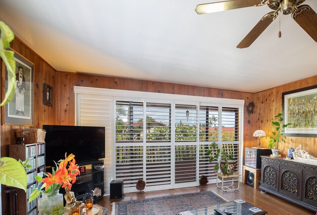 68-1853 W Kaupapa Pl, Waikoloa, HI 96738 - living area featuring wooden walls, a ceiling fan, and wood finished floors