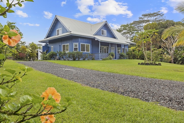 15-1948 12th Ave, Keaau, HI 96749 - view of front of house featuring a front yard, covered porch, board and batten siding, and gravel driveway