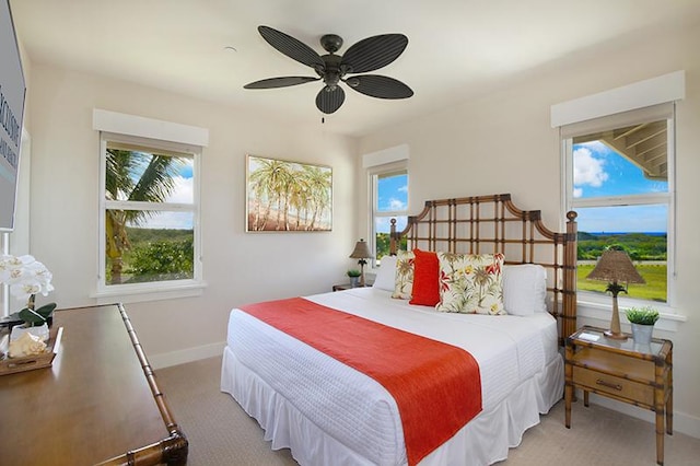2611 Kiahuna Plantation Dr Unit 13B, Koloa, HI 96756 - bedroom featuring light carpet, multiple windows, baseboards, and a ceiling fan