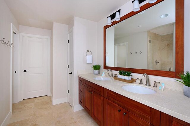 2611 Kiahuna Plantation Dr Unit 13B, Koloa, HI 96756 - bathroom with double vanity, a tile shower, and baseboards