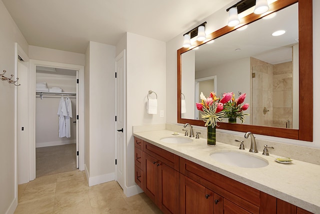 2611 Kiahuna Plantation Dr Unit 13B, Koloa, HI 96756 - full bathroom with double vanity, tiled shower, a spacious closet, and baseboards