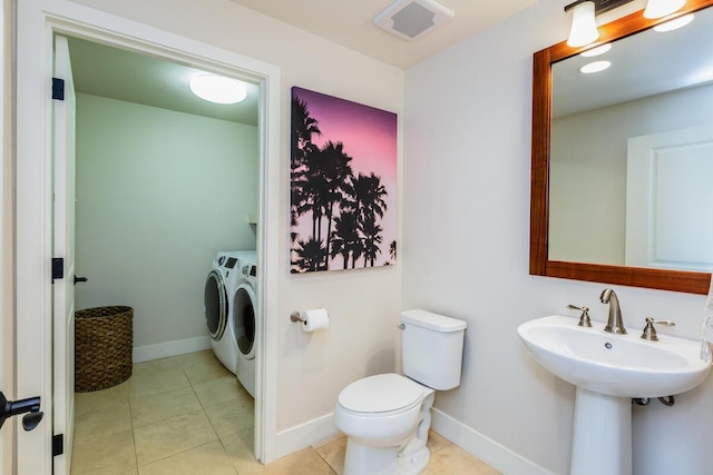 2611 Kiahuna Plantation Dr Unit 4G, Koloa, HI 96756 - bathroom with washing machine and clothes dryer, toilet, tile patterned flooring, and baseboards