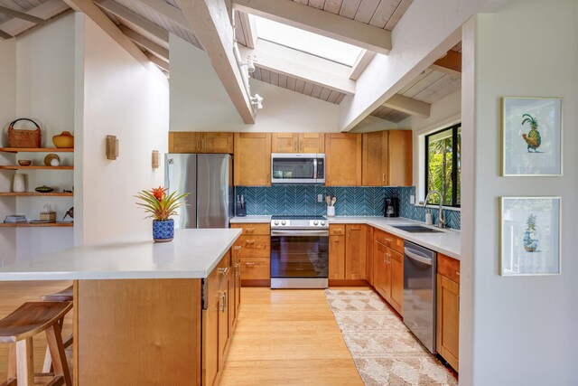 4160 Kalani Pl, Princeville, HI 96722 - kitchen featuring stainless steel appliances, a sink, decorative backsplash, light countertops, and light wood-style floors