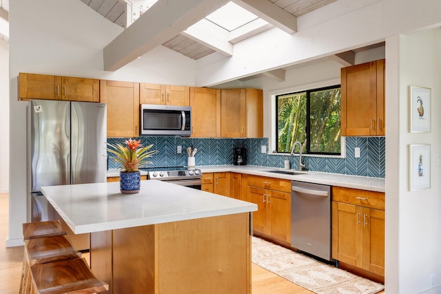 4160 Kalani Pl, Princeville, HI 96722 - kitchen featuring stainless steel appliances, a sink, light countertops, a breakfast bar, and decorative backsplash