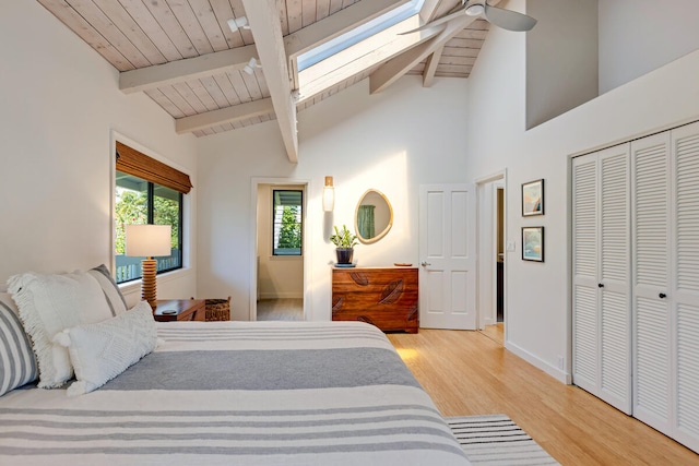 4160 Kalani Pl, Princeville, HI 96722 - bedroom with light wood-style flooring, a skylight, wood ceiling, a closet, and baseboards