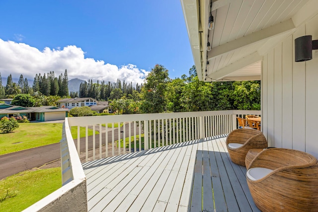 4160 Kalani Pl, Princeville, HI 96722 - wooden terrace with a mountain view, a lawn, and view of wooded area