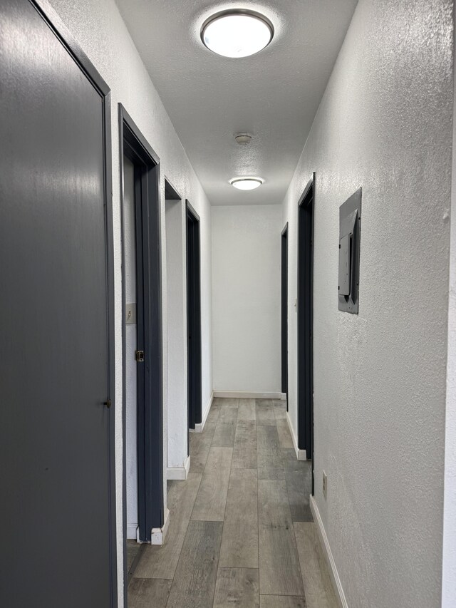 4528-B Hauaala Rd, Kapaa, HI 96746 - hallway with a textured wall, wood finished floors, electric panel, and baseboards