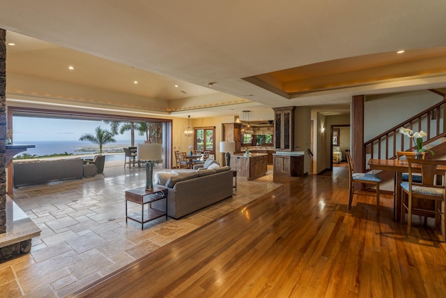 76-863 Pakalakala Pl, Kailua-Kona, HI 96740 - living area featuring a raised ceiling, decorative columns, recessed lighting, stairs, and wood finished floors