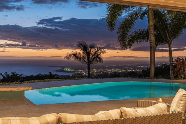 76-863 Pakalakala Pl, Kailua-Kona, HI 96740 - pool at dusk featuring an outdoor pool and a water view