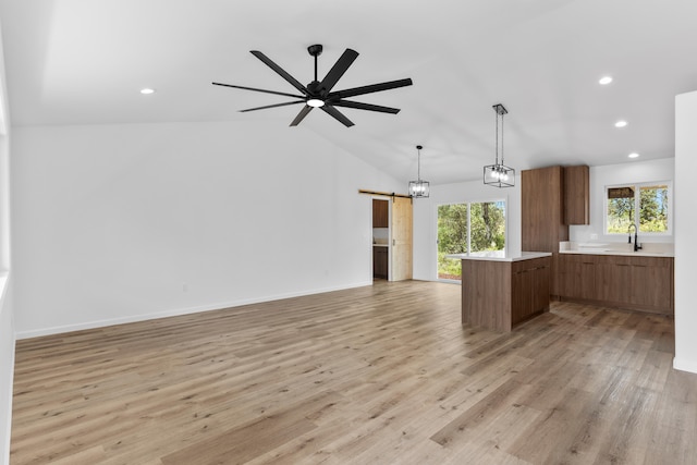 16-2071 Kuhio Dr, Pahoa, HI 96778 - kitchen featuring a barn door, brown cabinets, a sink, a center island, and open floor plan