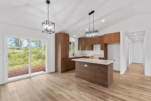16-2071 Kuhio Dr, Pahoa, HI 96778 - kitchen with modern cabinets, vaulted ceiling, light wood finished floors, brown cabinets, and a chandelier