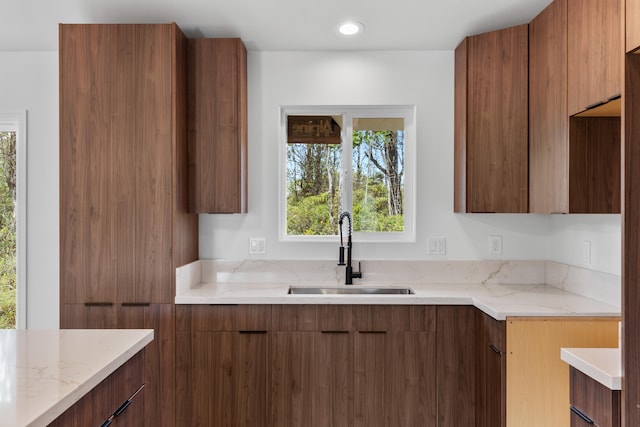 16-2071 Kuhio Dr, Pahoa, HI 96778 - kitchen featuring a sink, modern cabinets, light stone counters, and brown cabinetry