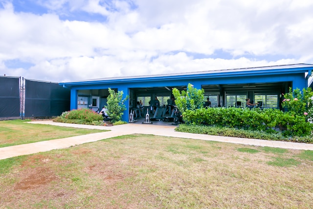 2253 Poipu Rd Unit 148, Koloa, HI 96756 - back of house with a lawn, concrete driveway, and an attached carport