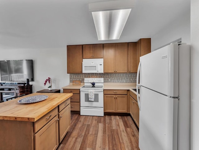 75-5766 Kuakini Hwy Unit 101, Kailua-Kona, HI 96740 - kitchen with white appliances, wooden counters, wood finished floors, decorative backsplash, and a center island