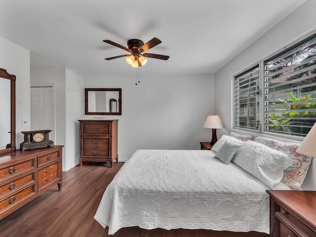 75-5766 Kuakini Hwy Unit 101, Kailua-Kona, HI 96740 - bedroom featuring dark wood-style flooring, a ceiling fan, and baseboards