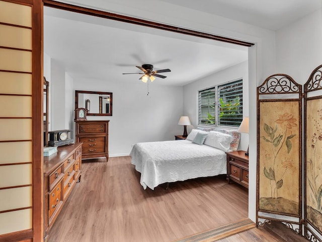 75-5766 Kuakini Hwy Unit 101, Kailua-Kona, HI 96740 - bedroom with light wood finished floors, baseboards, and a ceiling fan