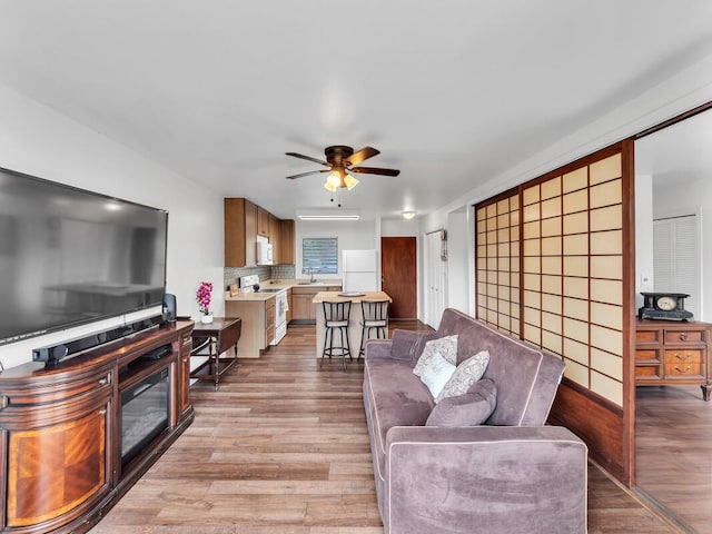 75-5766 Kuakini Hwy Unit 101, Kailua-Kona, HI 96740 - living area featuring ceiling fan and light wood finished floors
