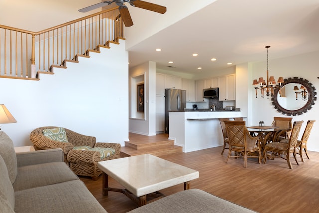 69-555 Waikoloa Beach Dr Unit 1704, Waikoloa, HI 96738 - living room with a chandelier, light wood-type flooring, ceiling fan, and recessed lighting